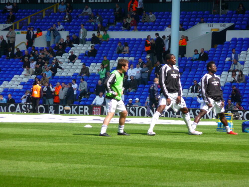 The Newcastle team warm up on the pitch.