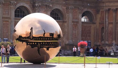 There's this massive brass ball in the centre of the Vatican gardens.  Some guy came up to it and set it spinning,.

Not sure what it represents, but I think it's by Arnaldo Pomodoro.