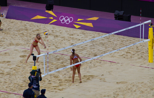 London 2012 - Beach Volleyball - Ladies Quarter Finals

Defending Olympic Champions Misty May-Treanor and Kerri Walsh Jennings practice an attack during the warmup.  They would go on to win the final.