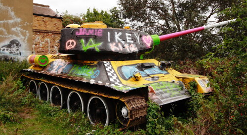 The turret is pointing the other way now, but it's still there.

https://en.wikipedia.org/wiki/Mandela_Way_T-34_Tank