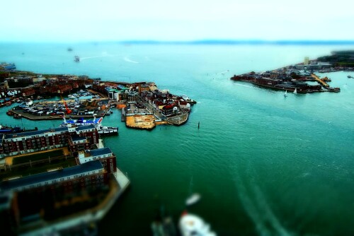 This is from a set of photos taken from the Spinaker Tower in Pompey, all over the period of about 1 hour.

Equipment:
 - Camera - EOS 550D
 - Lens - Canon 10-22mm, Canon 28-135mm
Workflow:
 - Canon DPP to remove the blue colour cast from the windows and resize down to 1616x1080
 - ImageMagick to create tilt-shift effect:
 
convert {input file} -sigmoidal-contrast 8x60% -modulate 100,150 \( +clone -blur 0x8 \) \( +clone -sparse-color Barycentric '0,0 black 0,%h white' -function polynomial 10,-10,2.5 \) -compose blend -set option:compose:args 100 -composite {output file}

 - Avidemux to stitch jpg into an XVid avi

Not sure I've got the ImageMagick stuff quite right for the tiltshift yet.

There are also a few frames where someone wearing light coloured clothes walked behind the camera, which reflected off of the glass.

There's also quite a bit of pixelation on the Flash video.